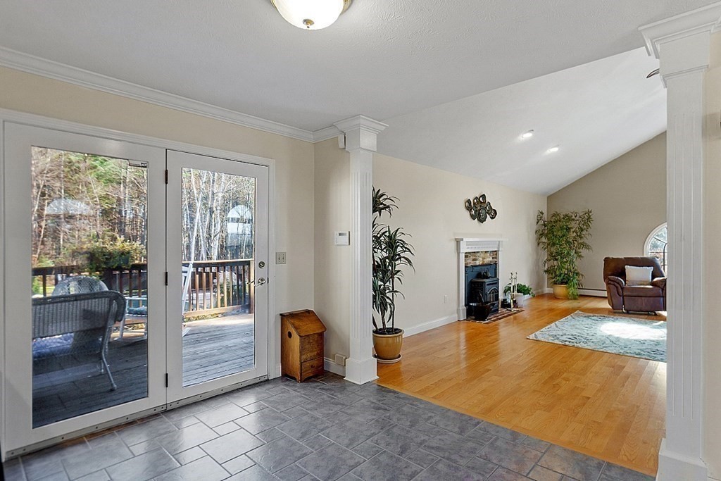 169 Wallace Hill Road Townsend, MA 01469 - Photo 9 of 42 a living room with furniture a window and a fireplace