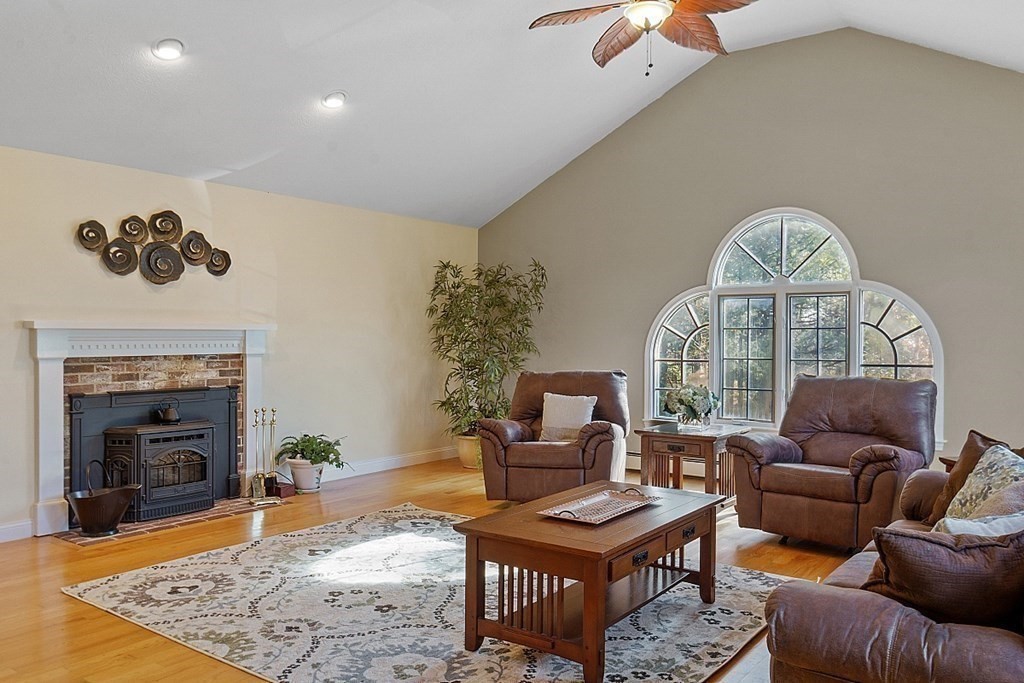 169 Wallace Hill Road Townsend, MA 01469 - Photo 10 of 42 a living room with furniture a fireplace and a chandelier