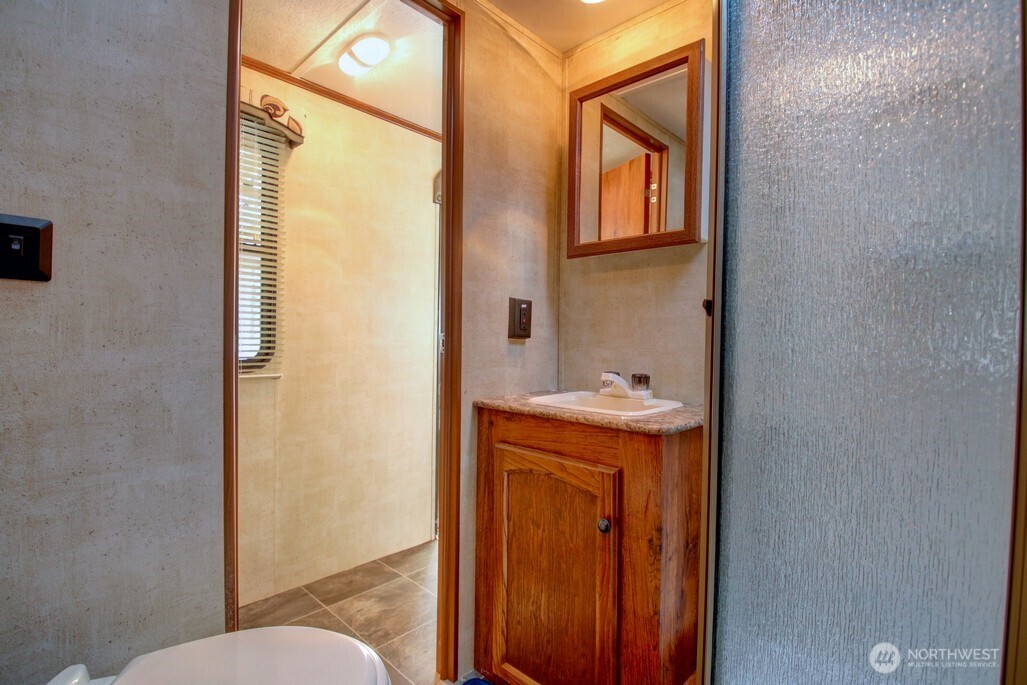 64 Wilderness Way Deming, WA 98244 - Photo 18 of 33 a bathroom with sink and mirror