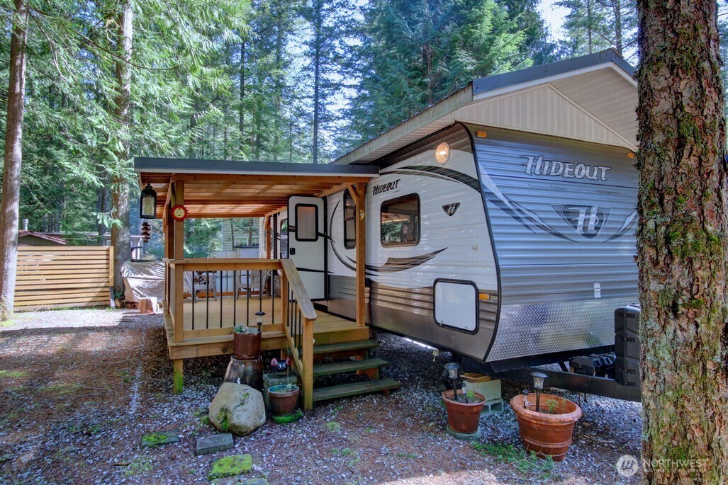 64 Wilderness Way Deming, WA 98244 - Photo 7 of 33 a front view of a house with garden and chairs