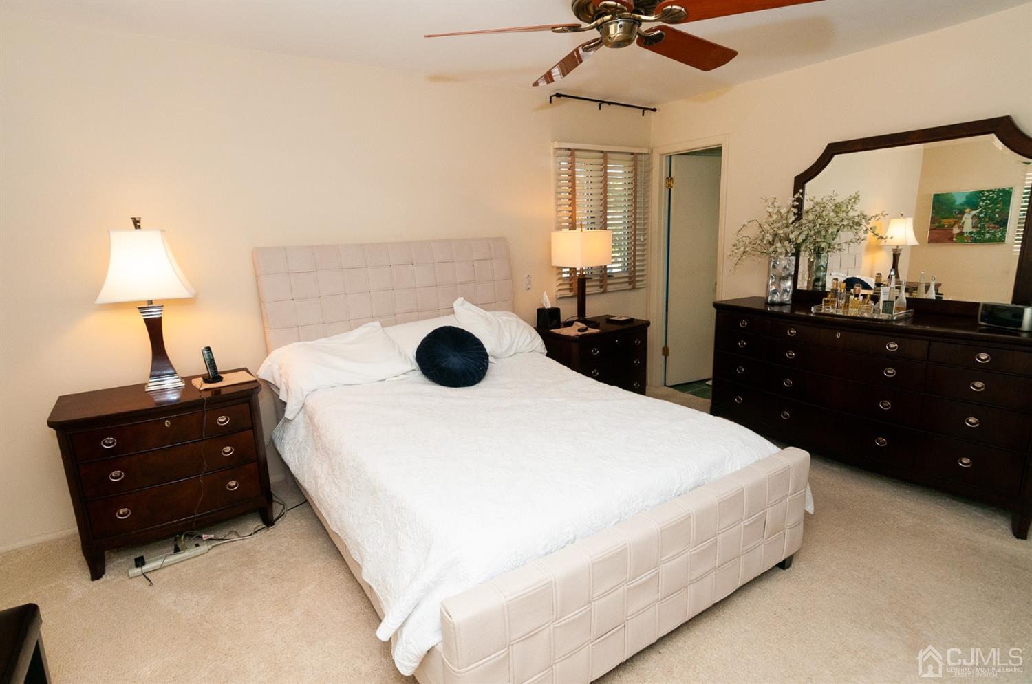 82 Harmon Road Edison, NJ 08837 - Photo 23 of 47 a bedroom with a bed and a chandelier