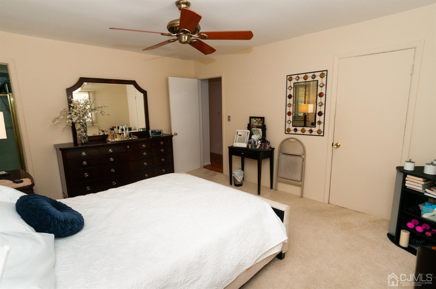 82 Harmon Road Edison, NJ 08837 - Photo 24 of 47 a bedroom with a bed and a chandelier