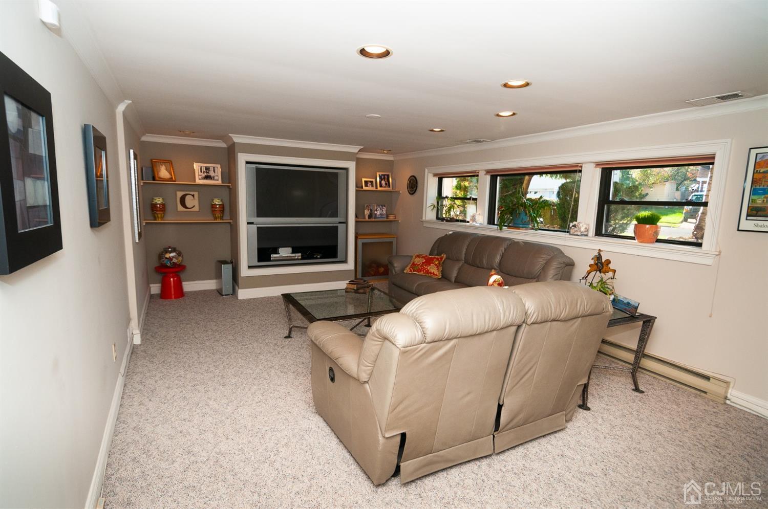 82 Harmon Road Edison, NJ 08837 - Photo 29 of 47 a living room with furniture and a flat screen tv