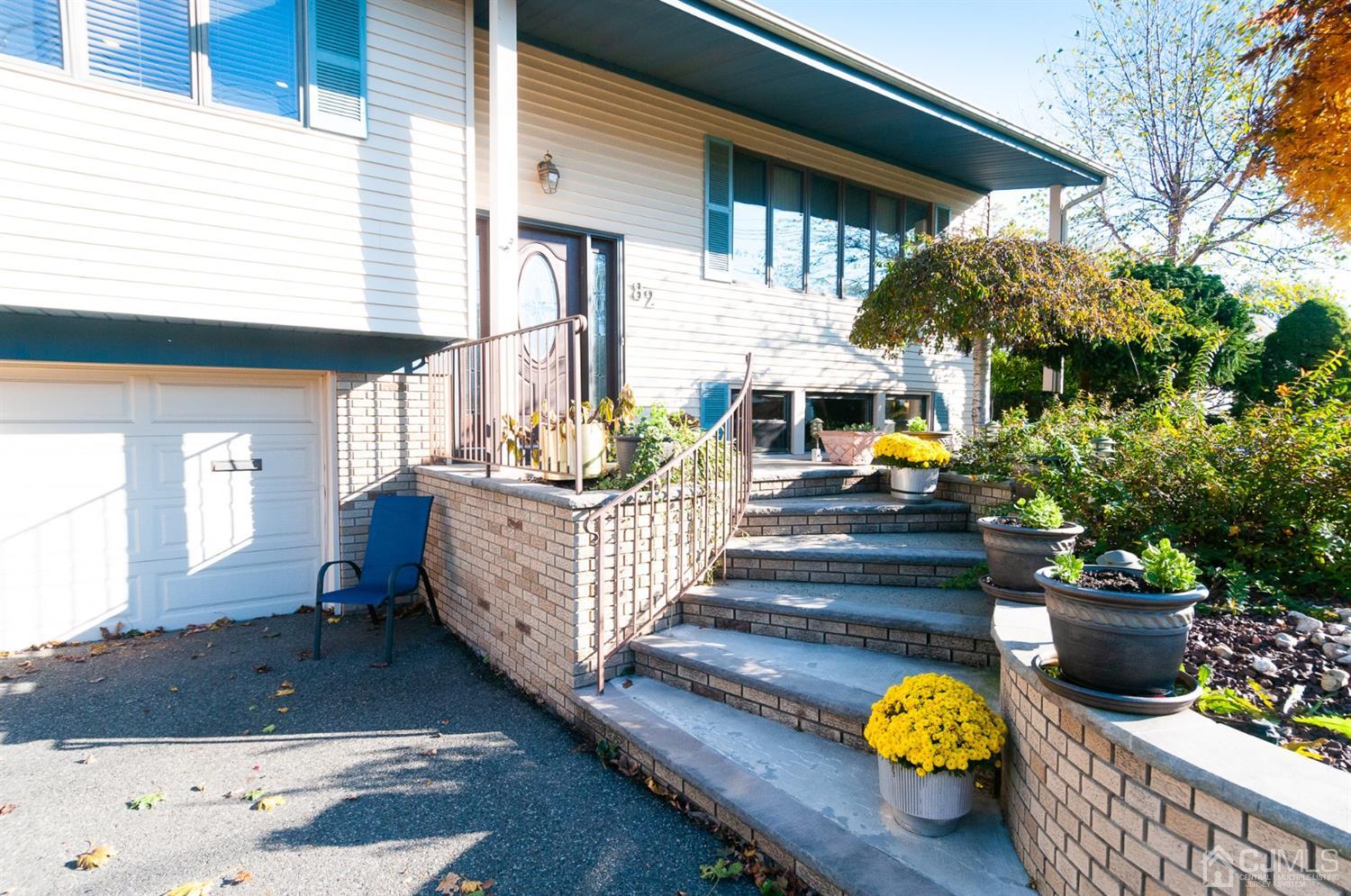 82 Harmon Road Edison, NJ 08837 - Photo 4 of 47 a front view of a house with outdoor seating and wooden floor