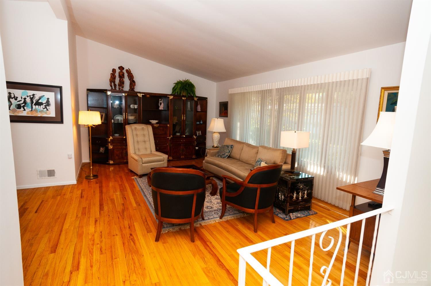 82 Harmon Road Edison, NJ 08837 - Photo 6 of 47 a living room with furniture a dining table and wooden floor