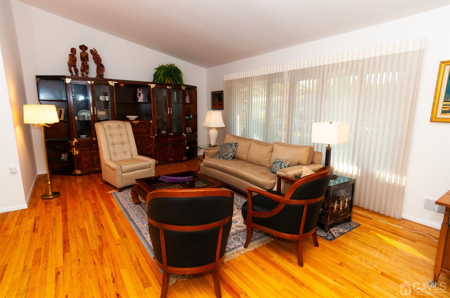 82 Harmon Road Edison, NJ 08837 - Photo 7 of 47 a living room with furniture a wooden floor and next to a window