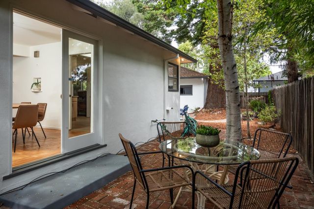 a dining room with furniture and wooden fence