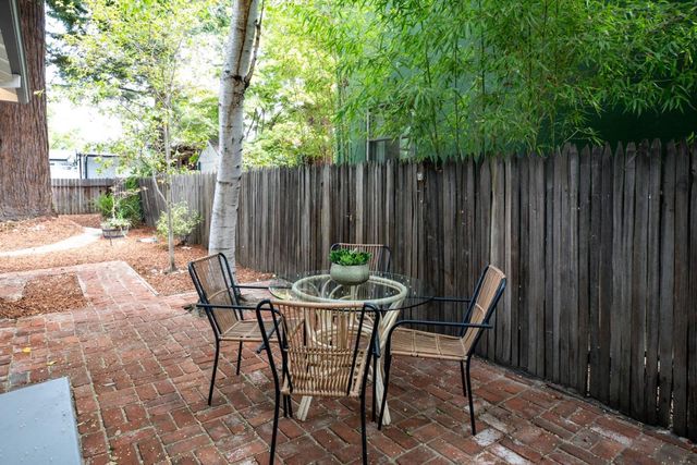 a backyard of a house with outdoor seating