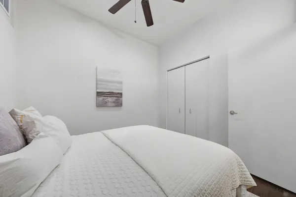 a bedroom with a bed and a window