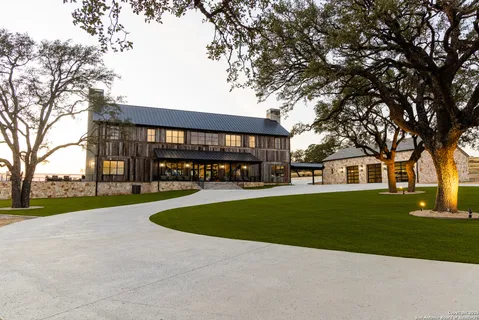 a view of a house with a yard and tree s