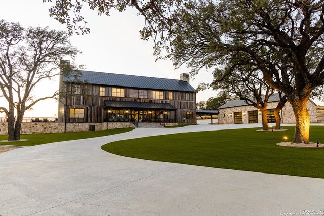 a view of a house with a yard and tree s
