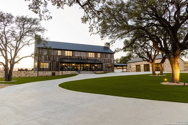 a view of a house with a yard and tree s
