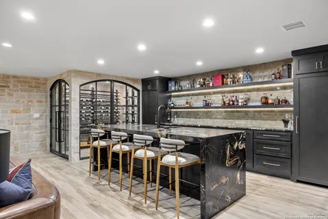 a living room with fireplace furniture and a large window