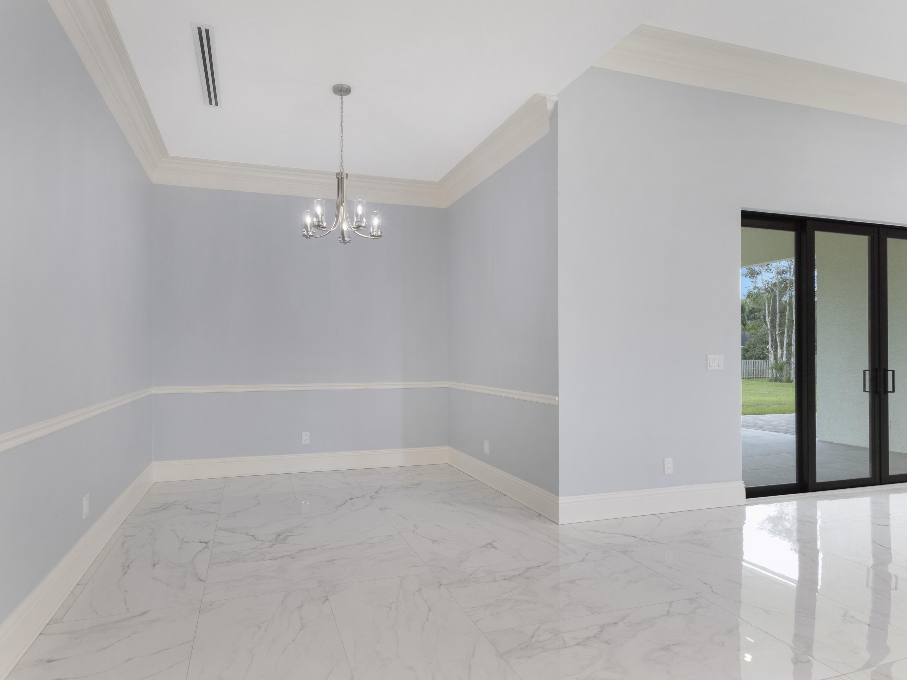 17436 71st Lane North Loxahatchee, FL 33470 - Photo 20 of 50 a view of a room with racks on the wall