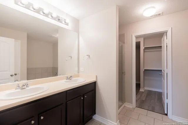 a bathroom with a double vanity sink a and mirror