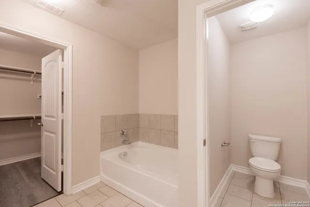 a bathroom with a bathtub and a toilet