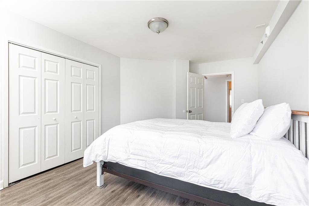 1501 Clairmont Road, Unit 1525 Decatur, GA 30033 - Photo 11 of 26 a bedroom with a bed and wooden floor