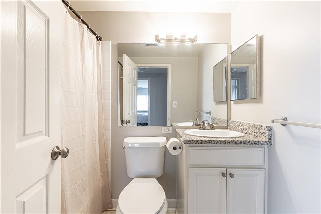 1501 Clairmont Road, Unit 1525 Decatur, GA 30033 - Photo 12 of 26 a bathroom with a toilet sink and mirror