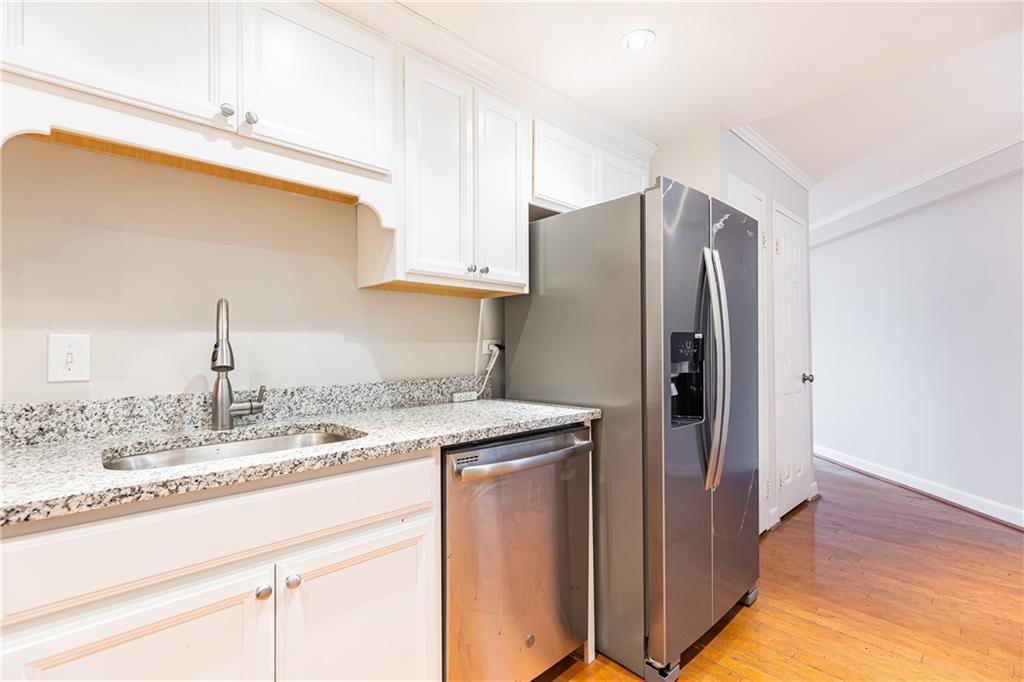 1501 Clairmont Road, Unit 1525 Decatur, GA 30033 - Photo 3 of 26 a kitchen with stainless steel appliances granite countertop a refrigerator and a sink