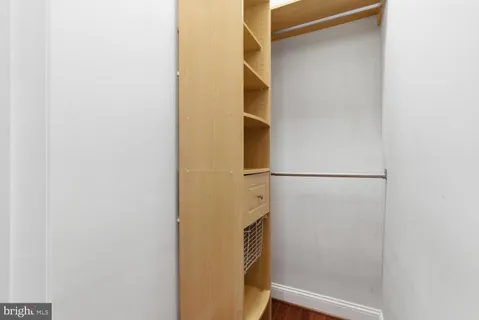 a view of walk in closet with empty room