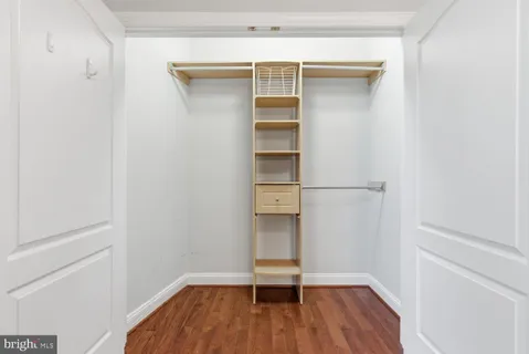a view of walk in closet with empty racks