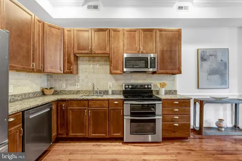 a kitchen with wooden cabinets and a stove top oven