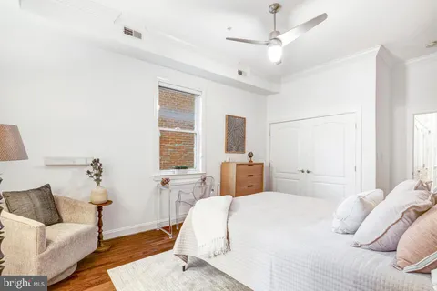 a bedroom with a large bed and a couch