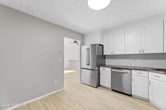 a kitchen with stainless steel appliances a refrigerator and cabinets