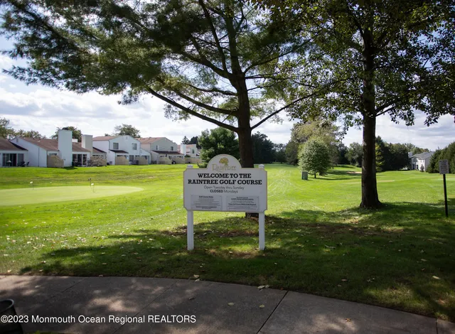 a view of a house with backyard and a tree