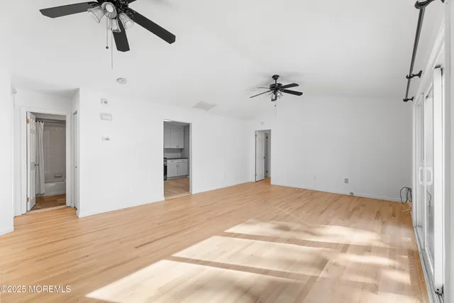 a view of a room with a ceiling fan