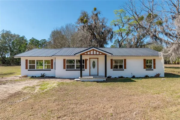 a front view of a house with yard