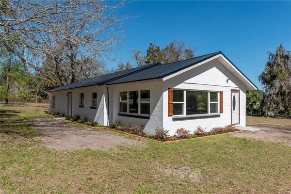 a front view of house with yard outdoor seating and barbeque oven
