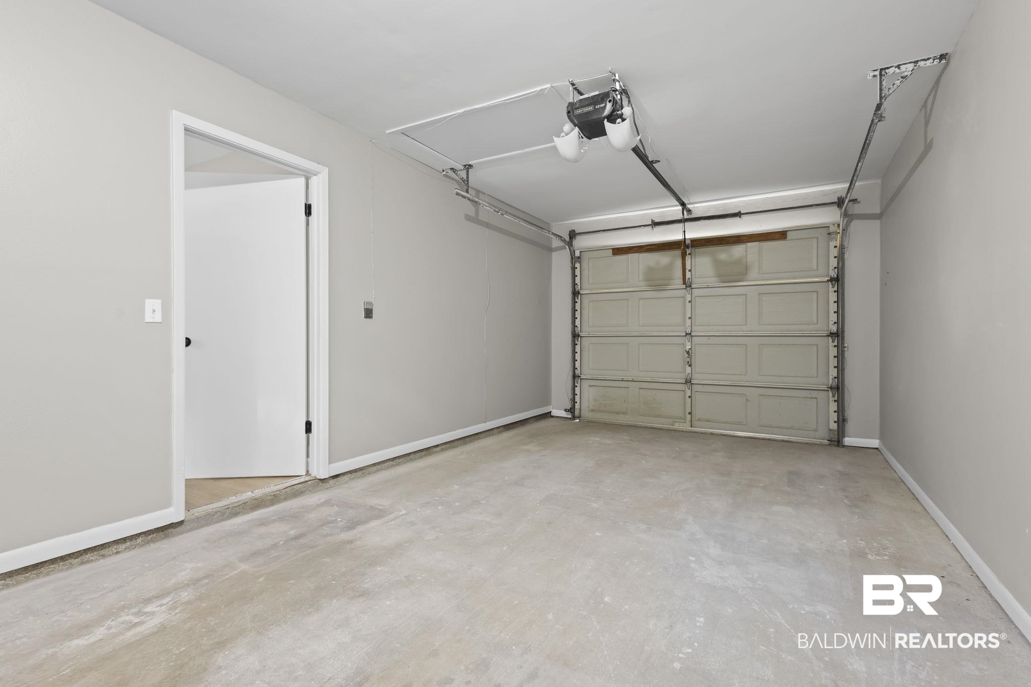 309 West Roosevelt Avenue Foley, AL 36535 - Photo 22 of 60 Garage featuring a garage door opener