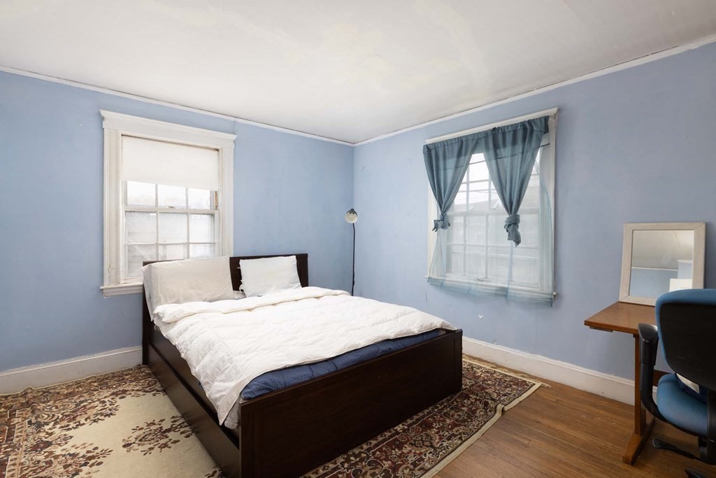 37 Wolcott Road Brookline, MA 02467 - Photo 8 of 12 a bed sitting in a bedroom next to a window