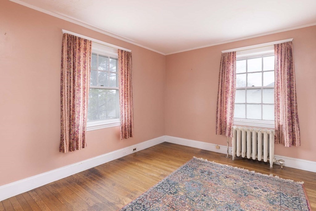 37 Wolcott Road Brookline, MA 02467 - Photo 9 of 12 an empty room with wooden floor and windows
