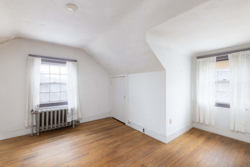 37 Wolcott Road Brookline, MA 02467 - Photo 10 of 12 an empty room with wooden floor and windows