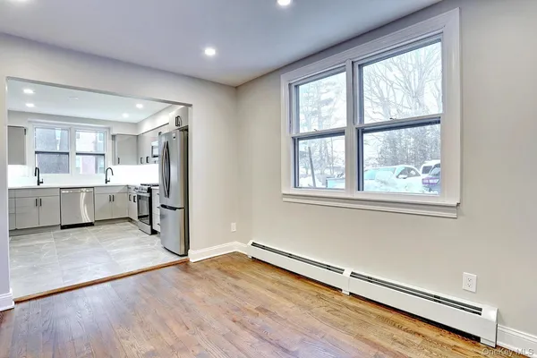 a view of a kitchen with a sink and a cabinet mirror