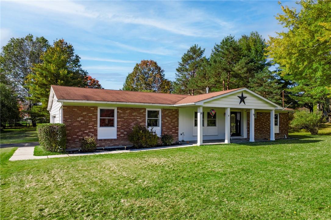 a front view of house with yard and green space