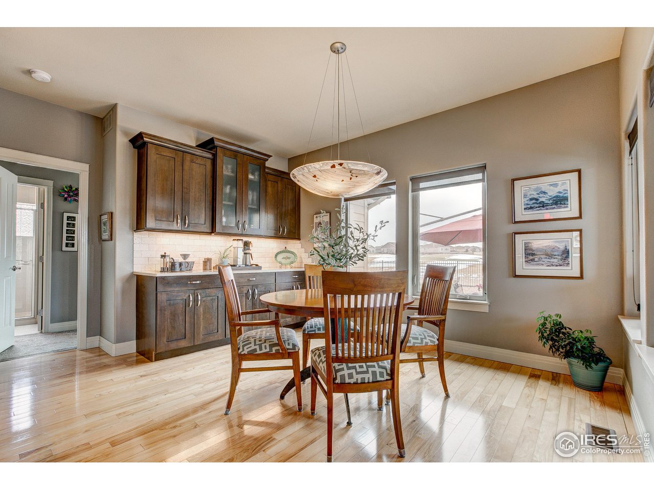 6001 Bay Meadows Drive Windsor, CO 80550 - Photo 19 of 39 Lovely Dining Area with Built-in Wood Cabinetry and Mountain Views!