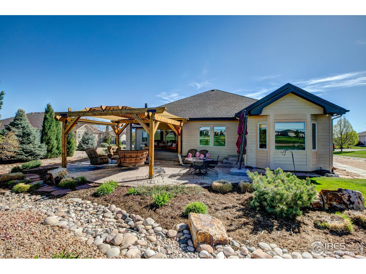 6001 Bay Meadows Drive Windsor, CO 80550 - Photo 7 of 39 Mostly Xeriscape Backyard with Year Round Foiliage