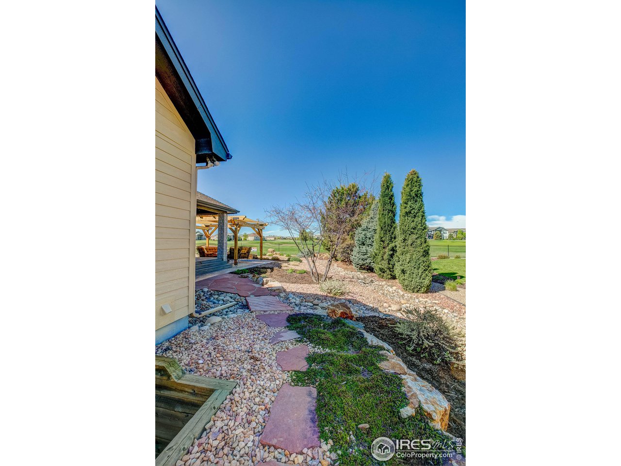 6001 Bay Meadows Drive Windsor, CO 80550 - Photo 8 of 39 Hardscape walkways to rear on both sides of the home