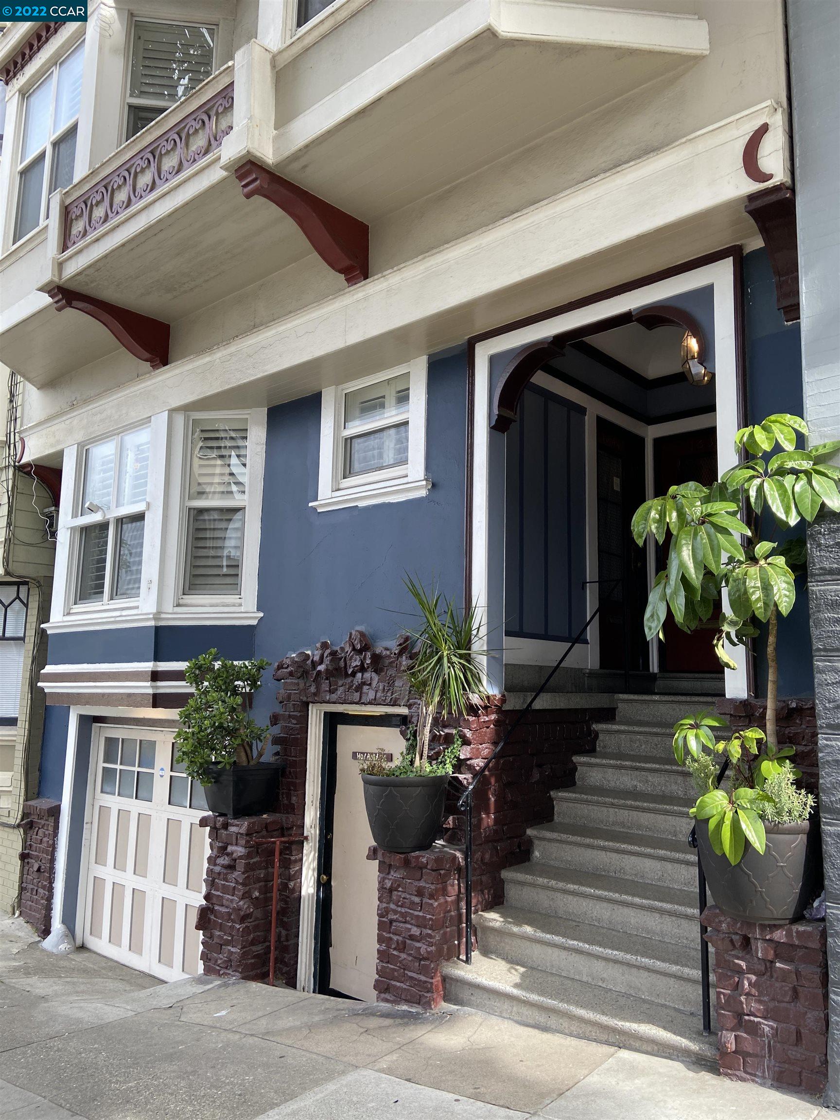 a front view of a house with outdoor seating and a potted plant