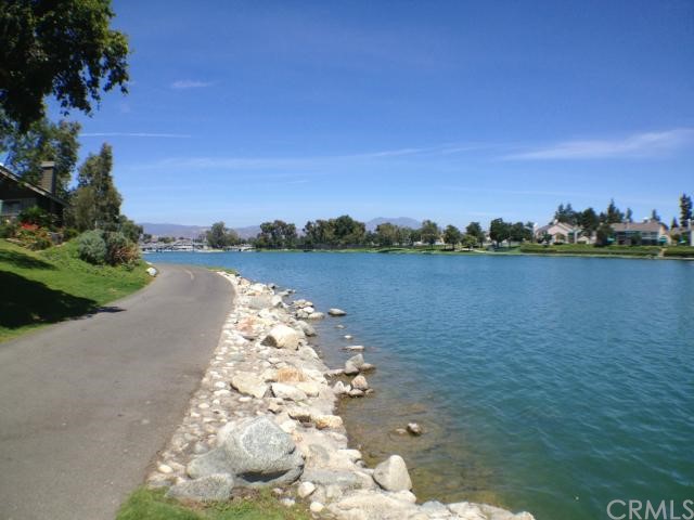 9 Greenleaf, Unit 7 Irvine, CA 92604 - Photo 1 of 1 a view of a lake with houses in the back