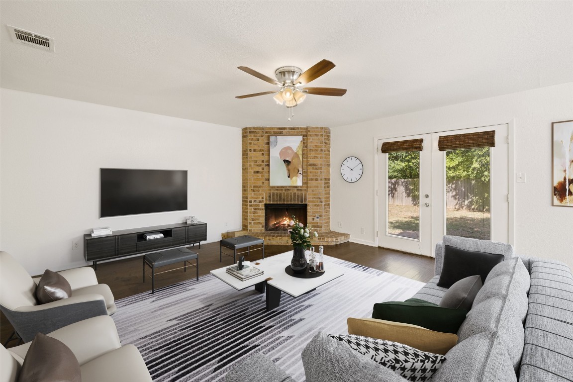 a living room with furniture a flat screen tv and a large window