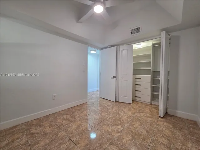 a view of an empty room and closet area