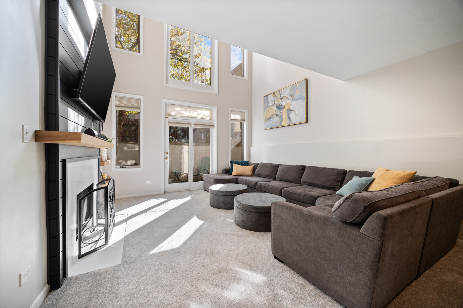 2106 West Erie Street, Unit 1E Chicago, IL 60612 - Photo 23 of 41 a living room with furniture a flat screen tv and a fireplace