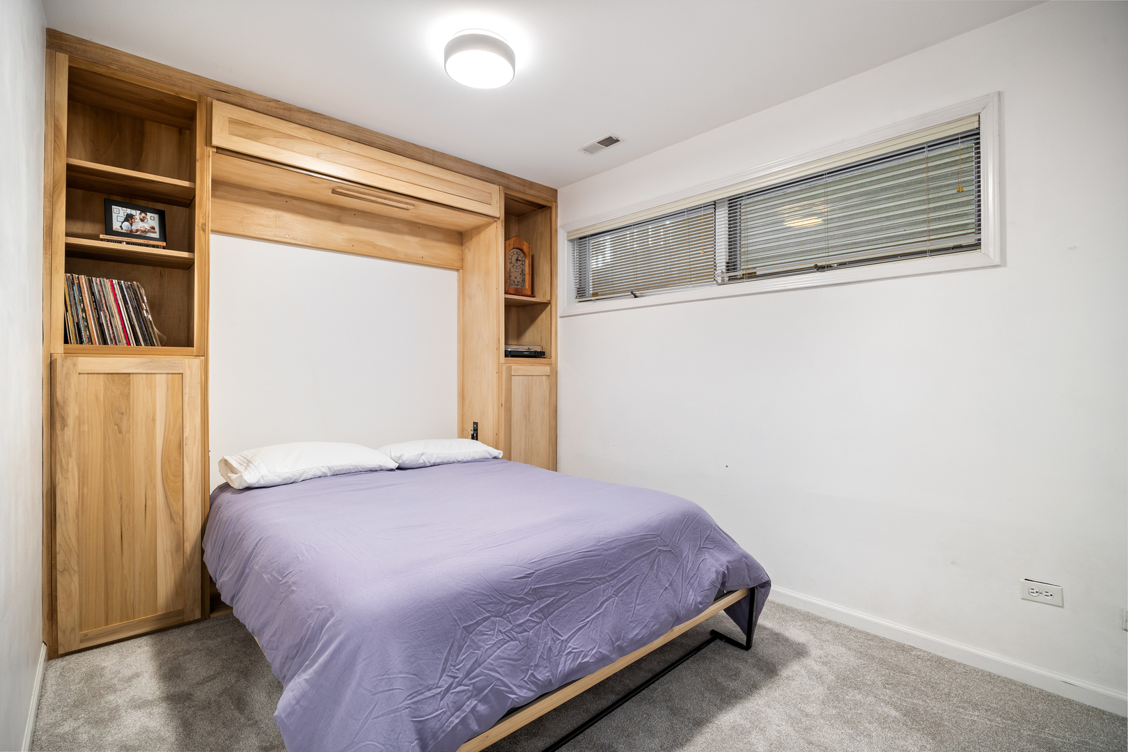 2106 West Erie Street, Unit 1E Chicago, IL 60612 - Photo 31 of 41 a bedroom with a bed and cabinets