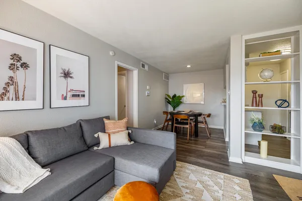 a living room with furniture and wooden floor