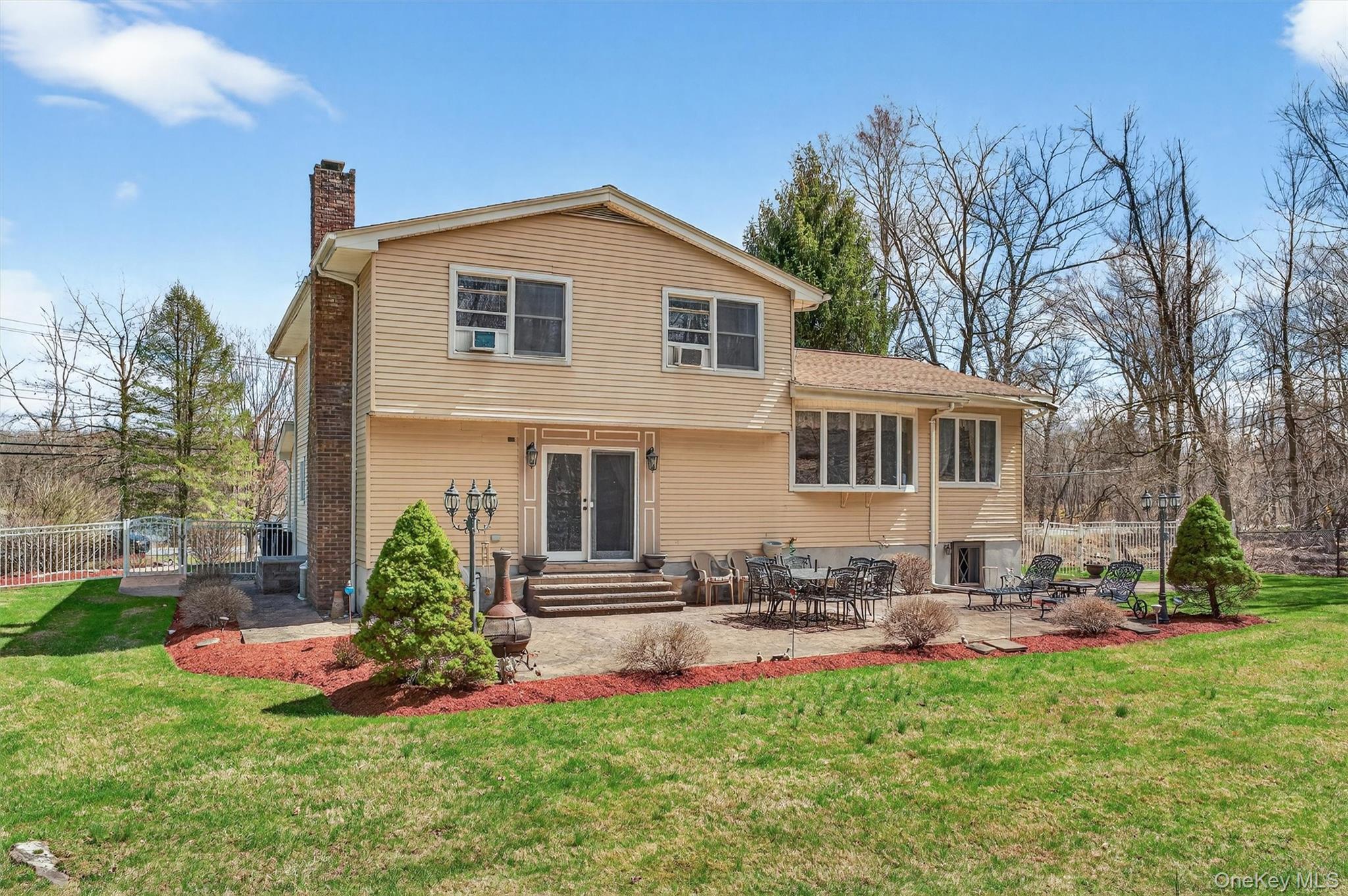 449 West Mombasha Road Monroe, NY 10950 - Photo 27 of 39 a front view of a house with a yard and outdoor seating