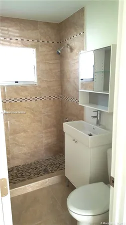 a room with furniture pool table and windows